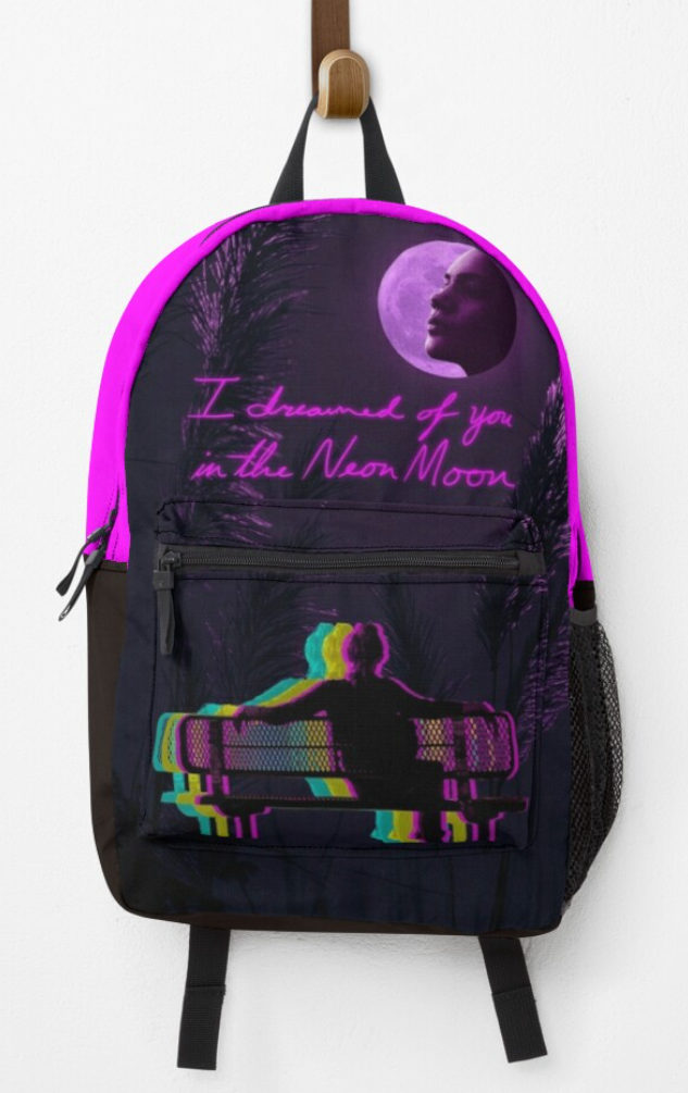 A black backpack with a neon pink top. The front pocket has a silhouette of a person on a bench backed in neon CMY colors looking up at a pink moon on the front of the backpack. The background has palms lit by the moon and scrawled in neon across the front reads "I dreamed of you in the Neon Moon".
